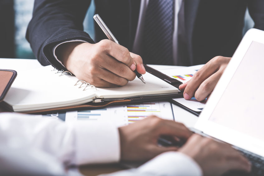 Business adviser analyzing financial figures denoting the progre